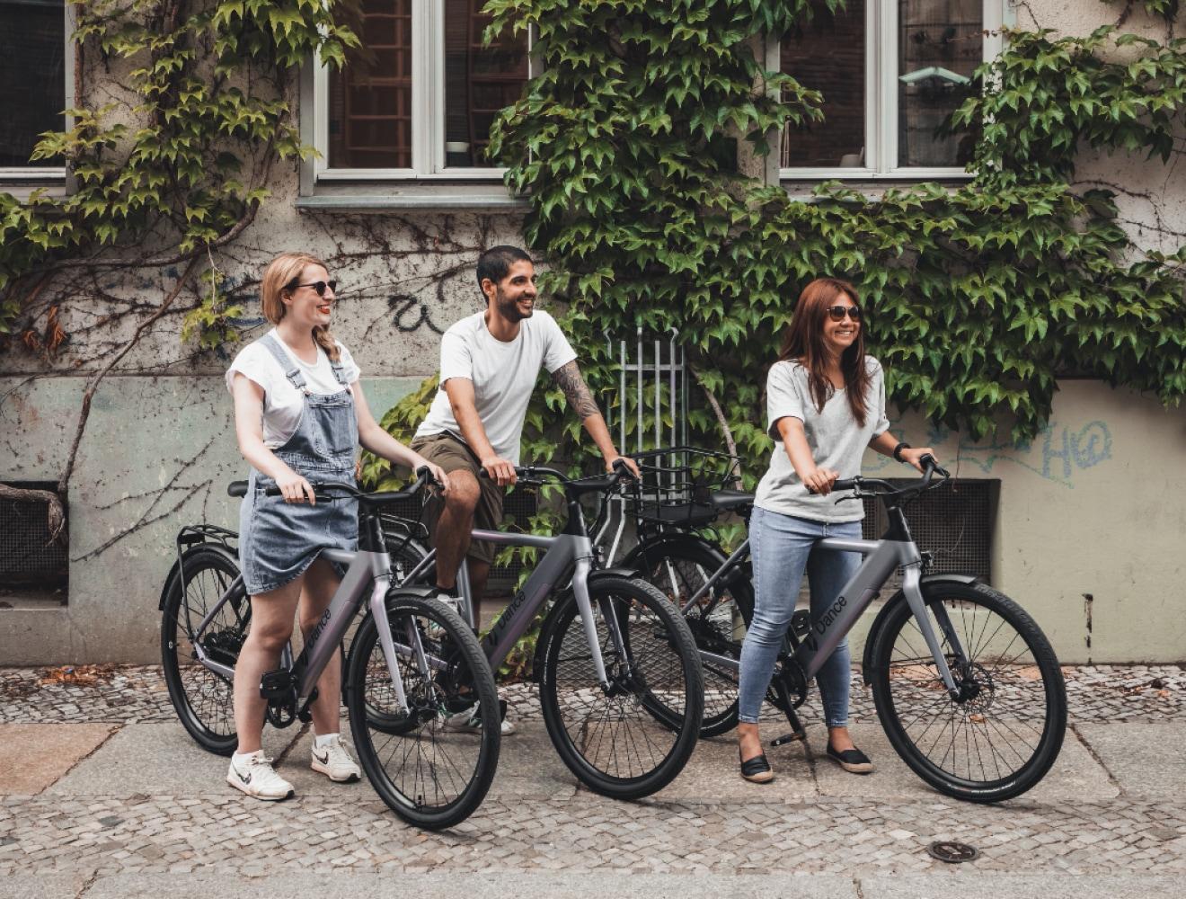 Side view of three people along with Dance bikes